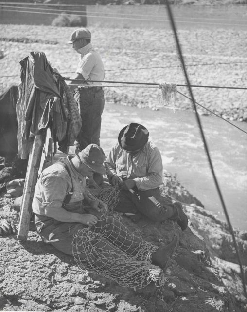 Indian fishermen repairing their nets Picture