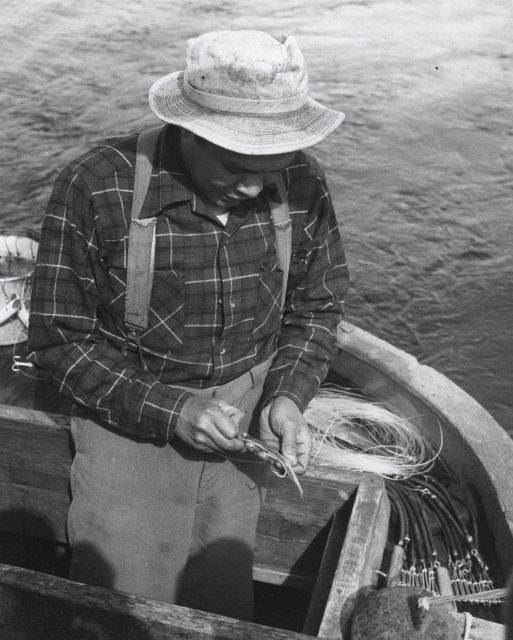 Placing bait on hook for salmon trolling Picture