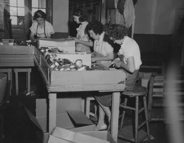Women on assembly line at sardine cannery Picture
