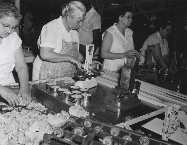 Hand filling and weighing tuna cans at De Jean Packing Co. Picture