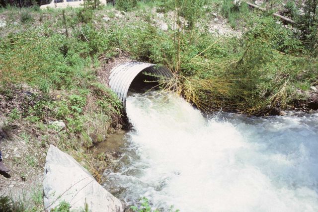 Culvert allowing flow of stream under road bed. Picture