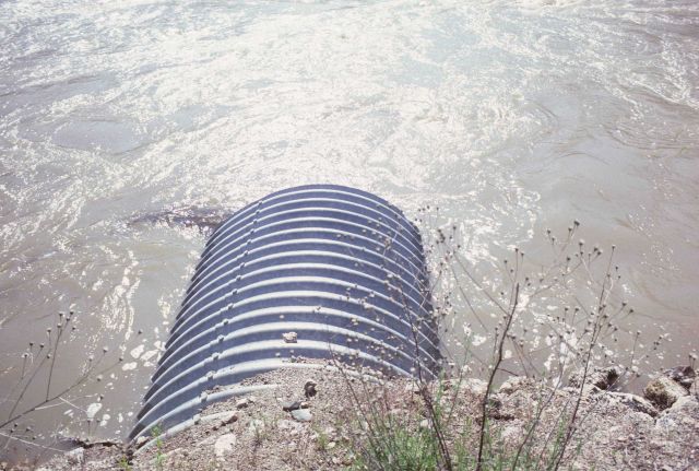 Culvert allowing flow of stream under road bed. Picture