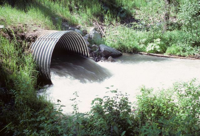 Culvert allowing flow of stream under road bed. Picture
