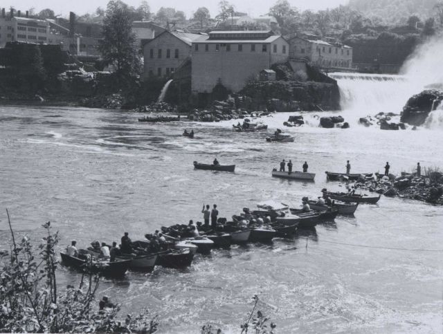 Fishermen taking advantage of salmon run and congregation of fish below ladders. Picture