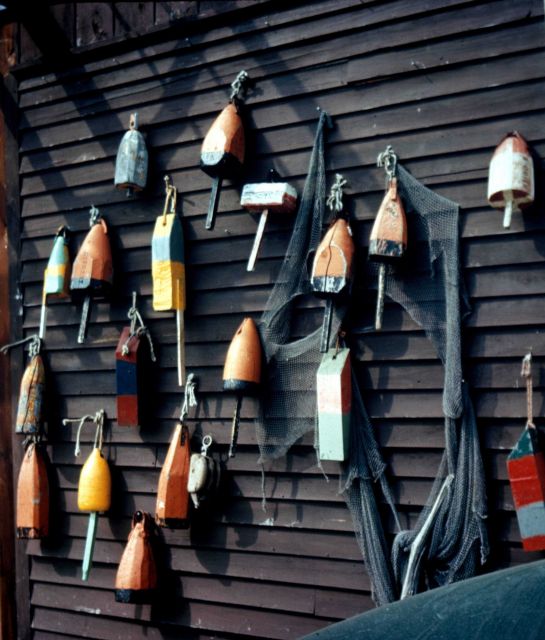 Lobster pot floats hanging on wall of house Picture