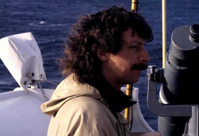 Michael Force, bird observer and zooplankton team member, is alert for marine mammals during the Drake Passage transit. Picture