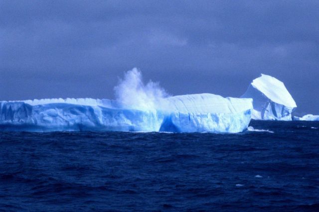 An iceberg at the moment it cleaves a large chunk of ice. Picture