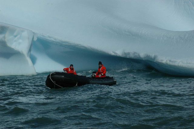 AMLR scientists Ryan Driscoll and Adam Jenkins in a Zodiac, next to an iceberg. Picture