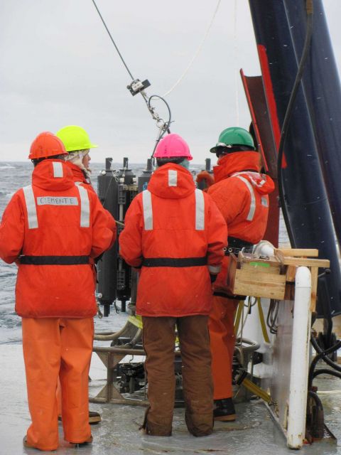 The AMLR crew works to deploy a CTD off the stern of the R/V Moana Wave. Picture