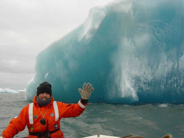 AMLR researcher Adam Jenkins next to an iceberg. Picture