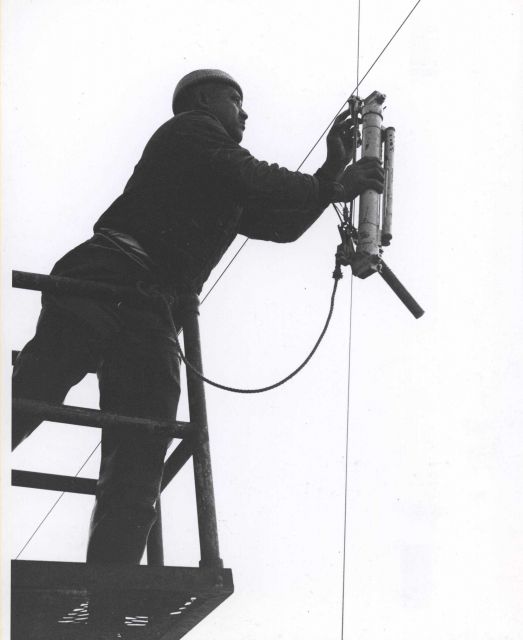 Deploying a Nansen bottle, used for measuring sub-surface temperature and to collect water samples for analysis. Picture
