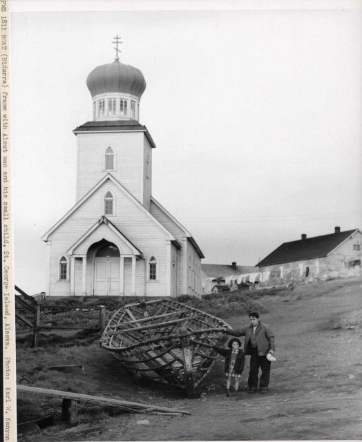 Frame of bidarra boat with Aleut man and his small child. Picture