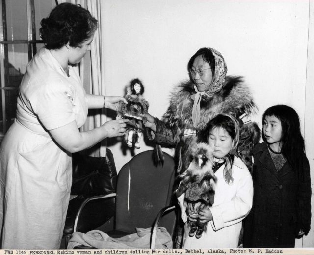 Eskimo woman and children selling fur dolls Picture
