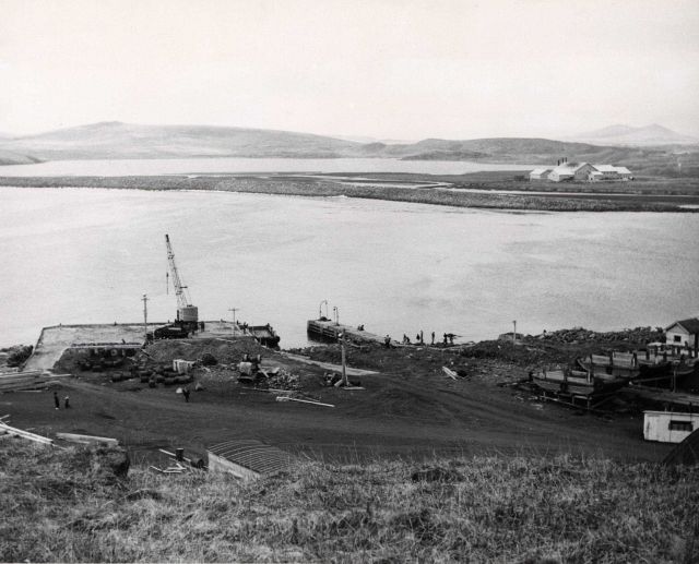 Village landing and marine ways with fur-seal byproducts plant in background. Picture