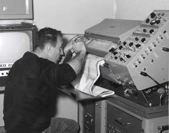 Electronics technician working on depth recorder on ALBATROSS IV Picture