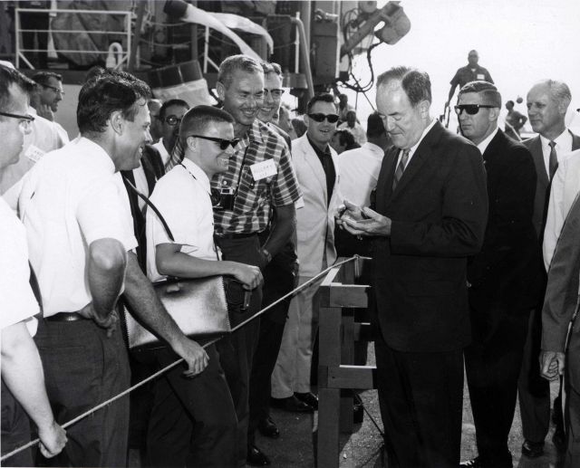 Vice President Hubert Humphrey autographs a polaroid photograph of himself taken by Barry Potvin, a BCF Woods Hole Laboratory summer student. Picture