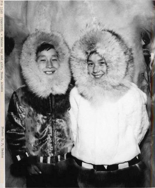 Eskimo boy and girl with fur-trimmed parkas. Picture