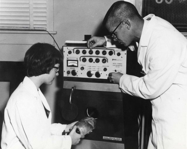 Fisheries biologists analyzing samples with auto-gamma spectrometer. Picture