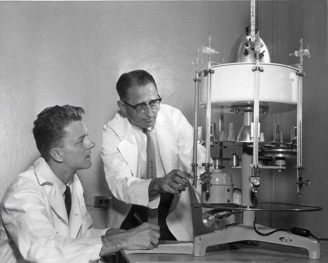 BCF scientists operating Warburg equipment for measurement of oxygen uptake by fish oils. Picture