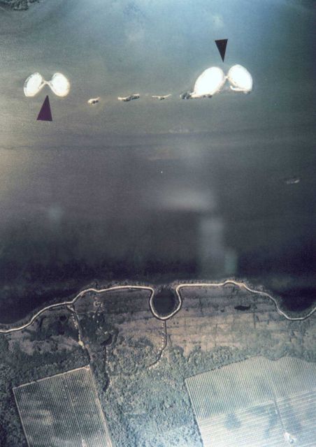 Aerial photograph of shoreline and apparently man-made islands. Picture