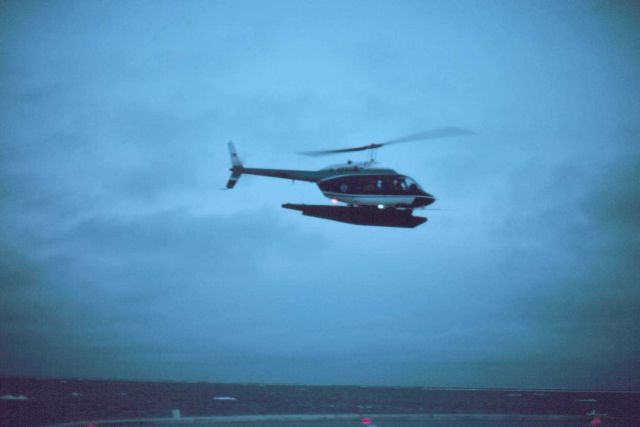 Lieutenant Budd Christman flying leased Bell 206 in Bering Sea. Picture