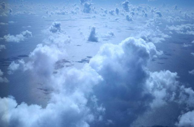 Cumulus, sun glint, and cloud shadows - or are those coastal islands? Picture