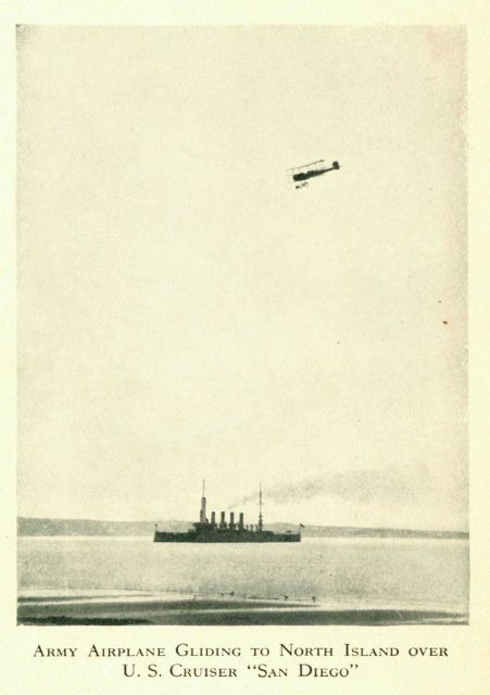 Army airplane gliding to North Island over US Cruiser 