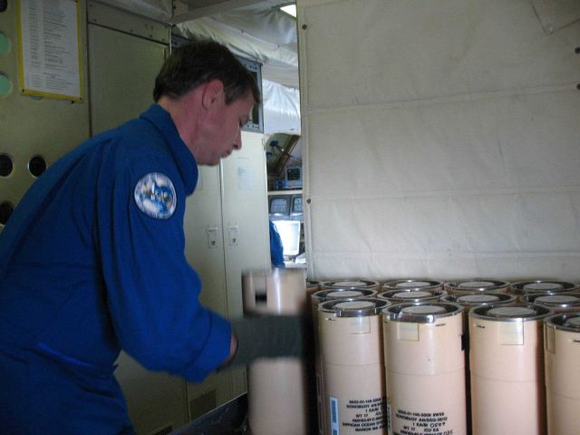 Joe Bosko obtaining bathythermograph sonobuoy for launching. Picture