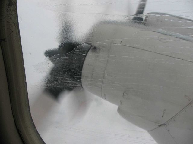 Rain streaks on a starboard side P-3 window while flying into a hurricane. Picture