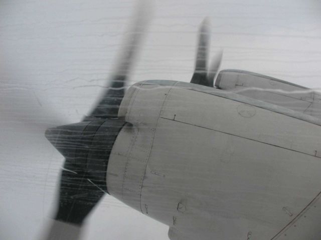 Rain streaks on a starboard side P-3 window while flying into heavy storms. Picture