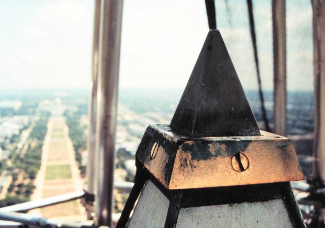 Aluminum tip of the Washington Monument with brass collar that holds lightning rods and brass rods extending down each side of the monument. Picture