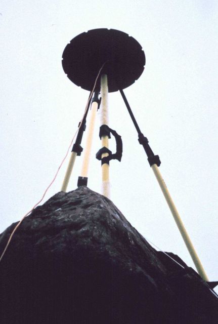GPS antenna and tripod set up over tidal bench mark on rock. Picture