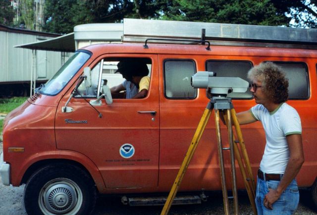 Instrument man observing during leveling operations. Picture