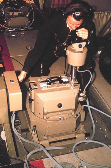 Aerial photographer, Charles Ferguson, operating Wild RC-10 camera installed on NOAA De Havilland Buffalo N13689. Picture