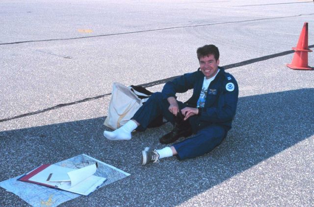 Lieutenant Mark Hickey preparing for aerial photographic mission on Rockwell Turbo Commander N53RF. Picture