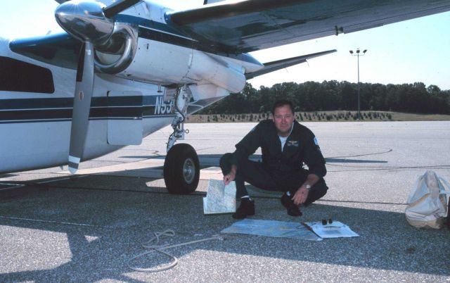 Lieutenant Commander Greg LaMontagne planning aerial photographic mission on Rockwell Turbo Commander N53RF. Picture