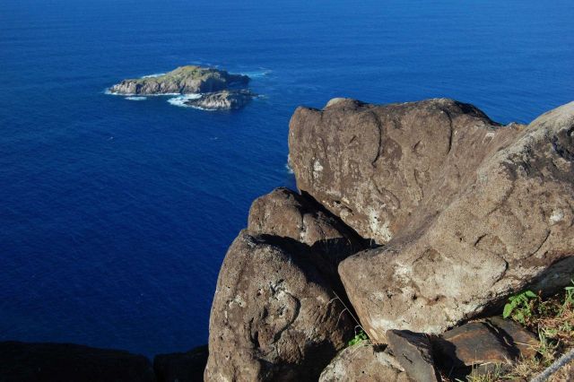 Human petroglyphs at Rano Kau overlooking Moto Nui. Picture