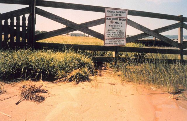 Erosion - ironically below a sign stating boat speed limit to minimize wake and erosion. Picture