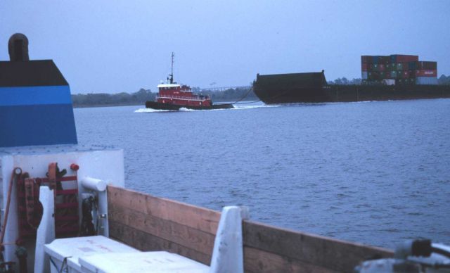 A barge-towing tugboat cruising by the FERREL during status and trends operations in Charleston Harbor. Picture