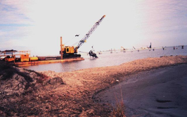 The Greenhill/East Timbalier dredging operation -- bucket dredge scooping material from channel which will be sent by pipe to the marsh creation site. Picture