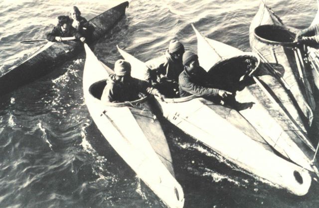 Eskimos congregating in their kayaks Picture