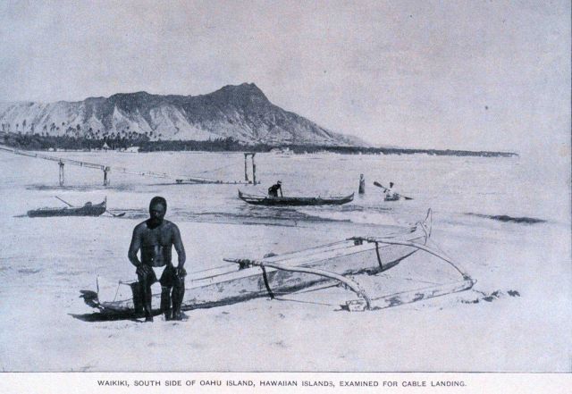 Native Hawaiian sitting on outrigger canoe with Diamondhead in the background Picture