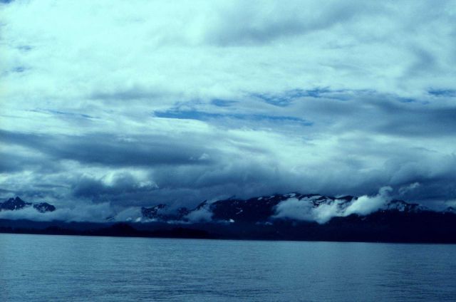 Clouds and mountains meet the sea on the Alaska Peninsula. Picture