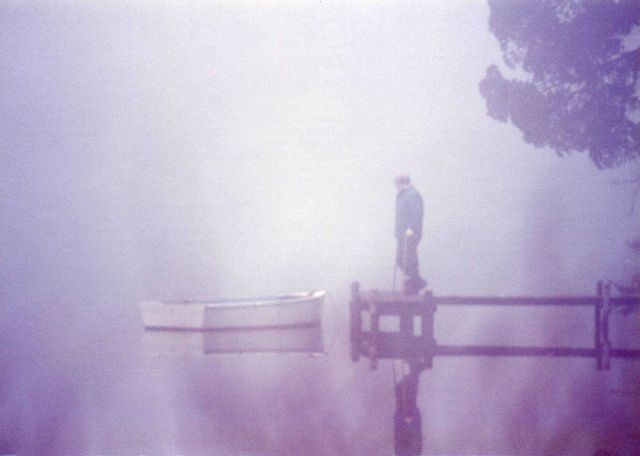 Fisherman checking his boat on a foggy morning. Picture
