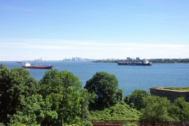 The 950-foot containership SEALAND COMMITMENT to right and New York skyline in center of photo. Picture