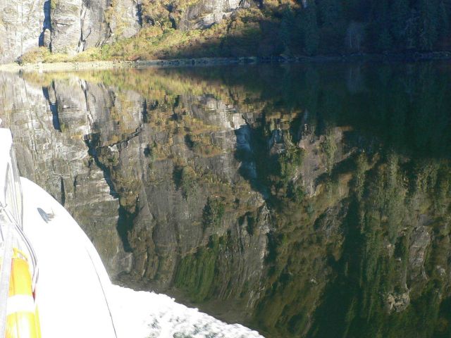 NOAA survey launch sailing through a rocky reflection. Picture