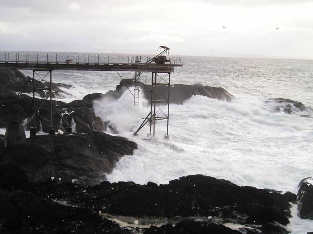 Surf roars over the remains of the old Coast Guard Pier at Cape Decision. Picture