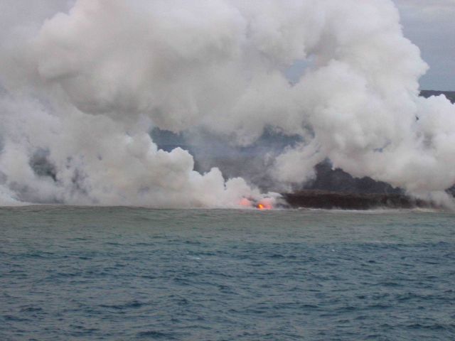 Lava flow entering the sea on SE coast of Hawaii. Picture