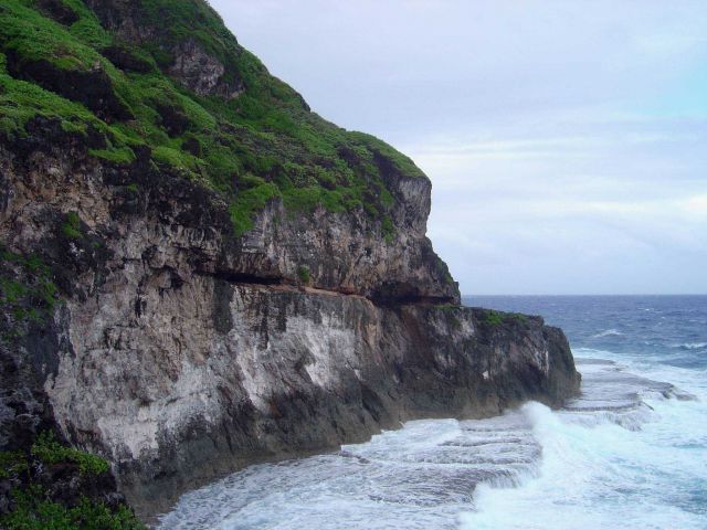 A wave-cut terrace inexorably being eroded by the sea on Guam. Picture