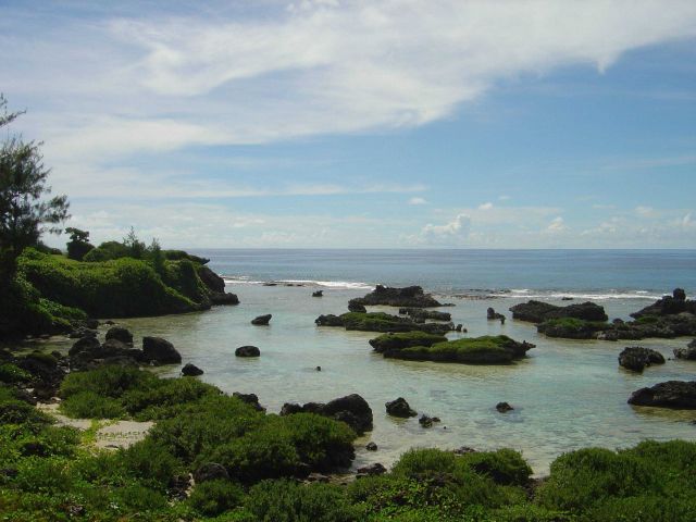 Coral rock islets in the reef flat behind the edge of the reef on Guam. Picture